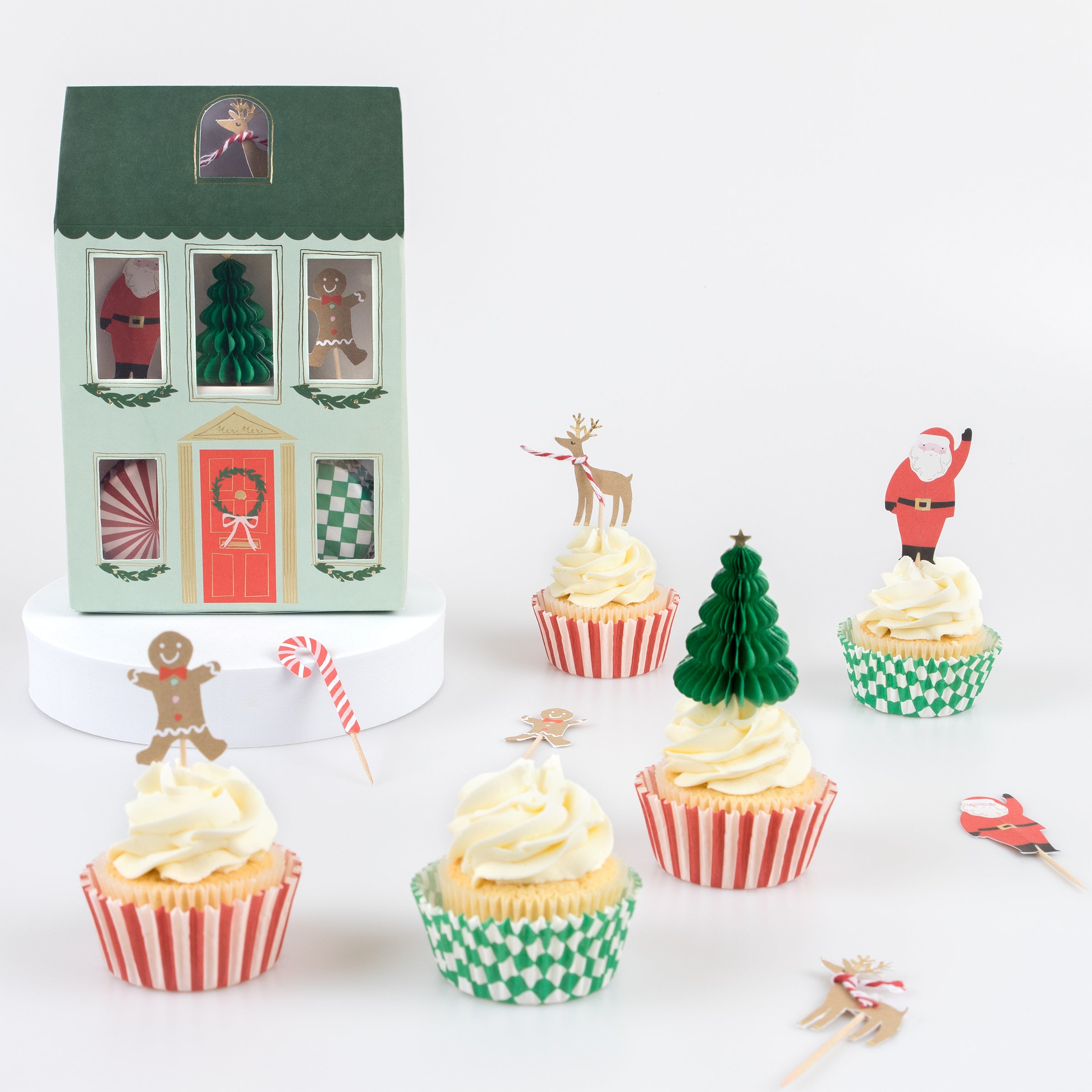 Make Christmas cupcakes with our Christmas cake toppers and cupcake cases, in a kit designed to look like a merry festive house.