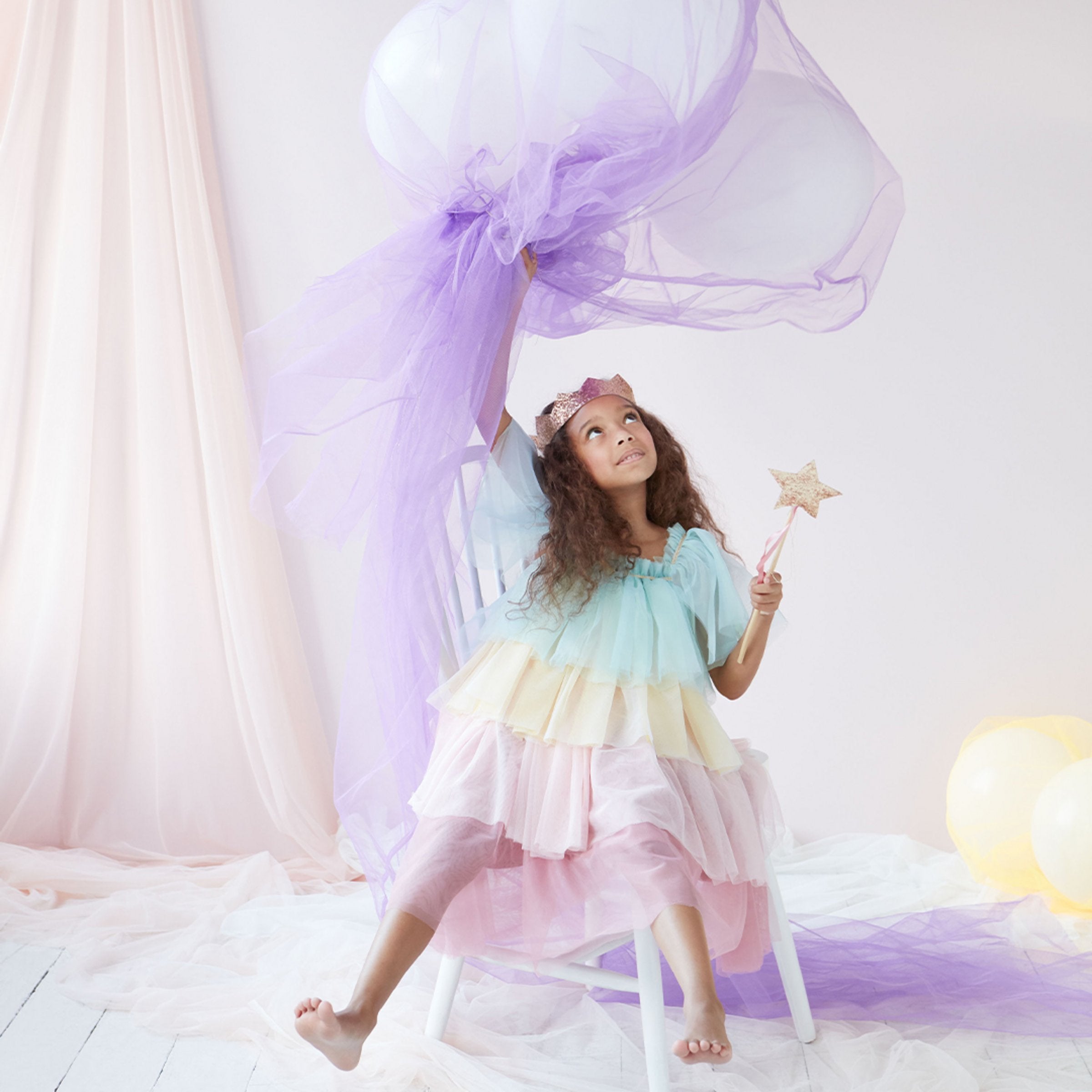 This princess costume for kids is made from colorful tulle layers and comes with a gold princess crown.