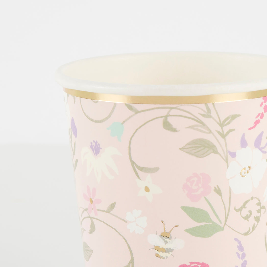 Beautiful pastel floral plates, cups, napkins, floral garland, and gold candles.