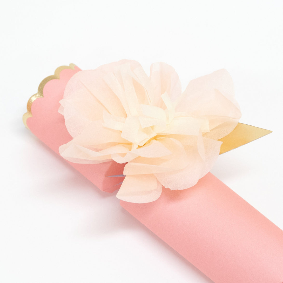 These pretty pink crackers are decorated with tissue paper flowers, and contain a tiara and sparkling glitter brooch.