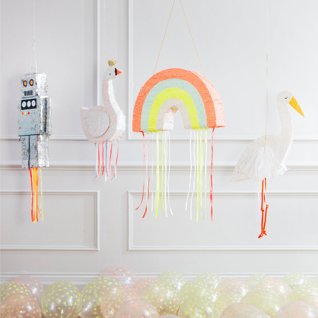 This rainbow pinata is beautifully decorated with colorful stripes and hanging ribbons.
