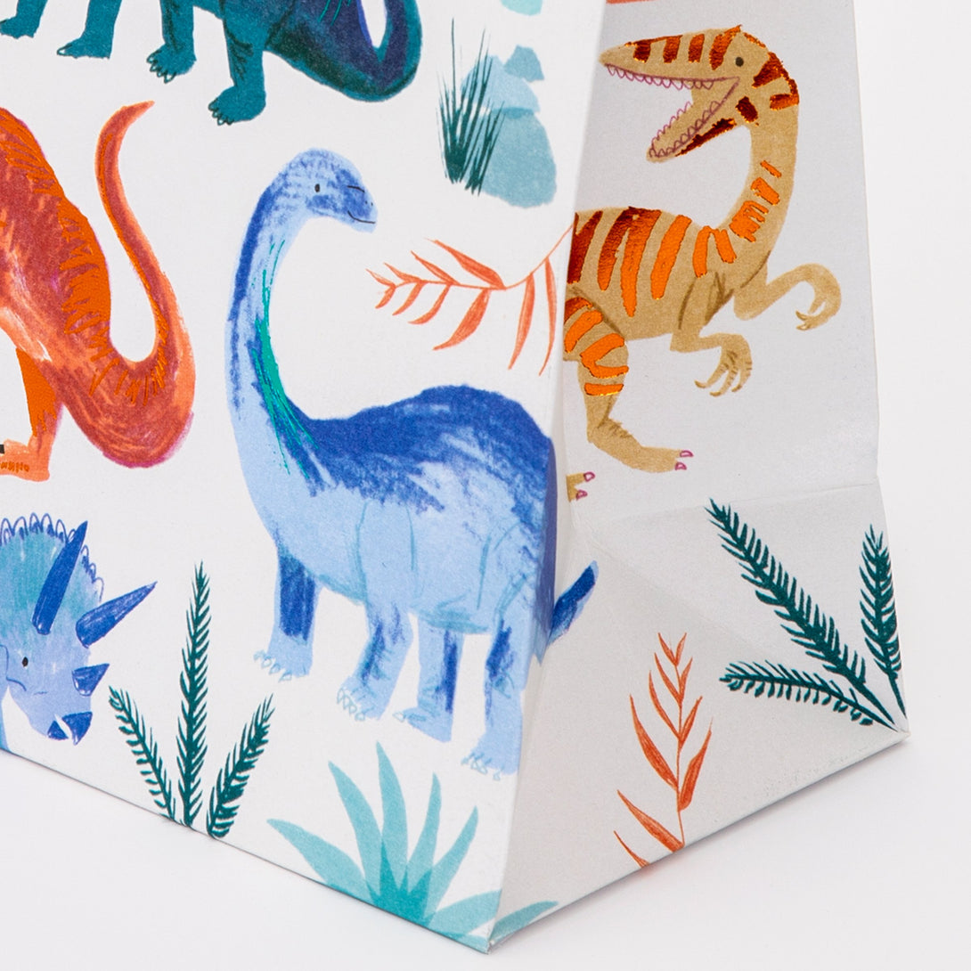 Our colorful dinosaur goodie bags, with a twisted paper handle, look amazing.