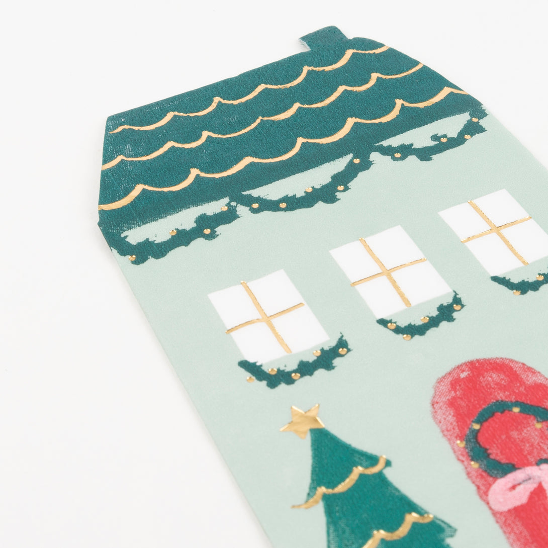 These Christmas paper napkins are designed to look like a home with Christmas decorations and gold foil detail.