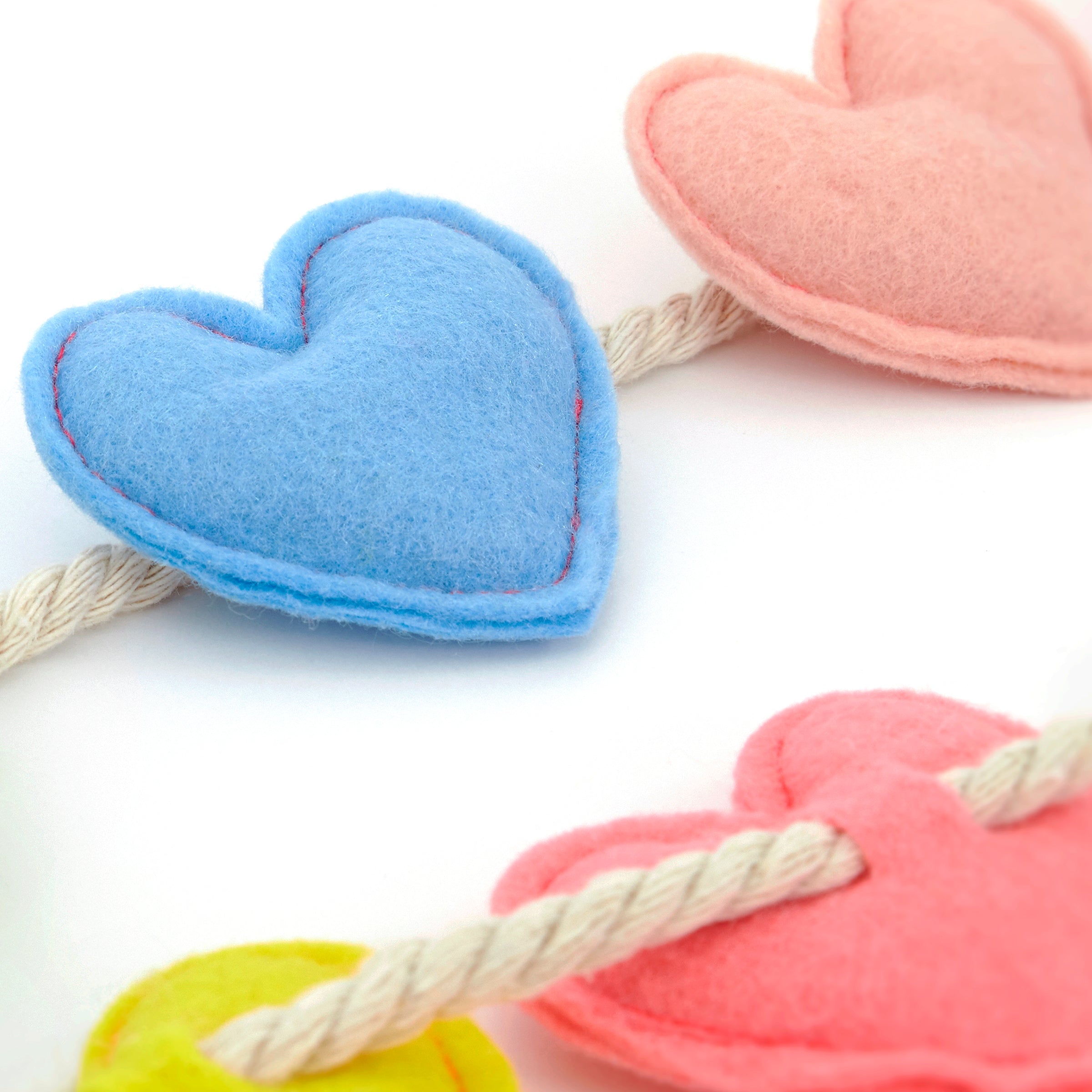 Our felt garland, featuring colorful hearts, is the perfect anniversary decoration or Valentine's Day decoration.