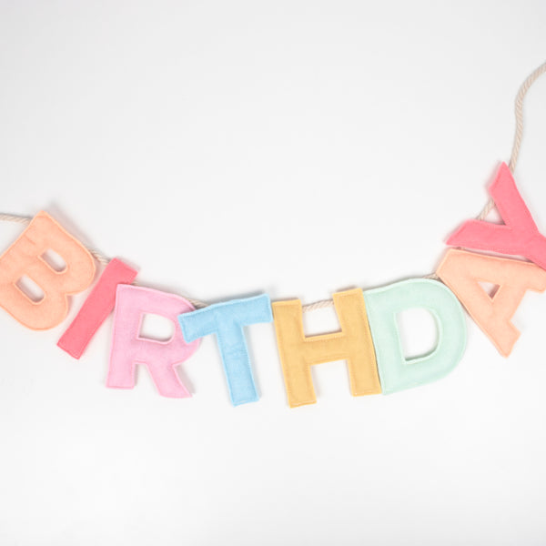 Add a rainbow of color to your birthday party supplies with a colorful felt garland, paper tablecloth and bright birthday cake candles. Image3