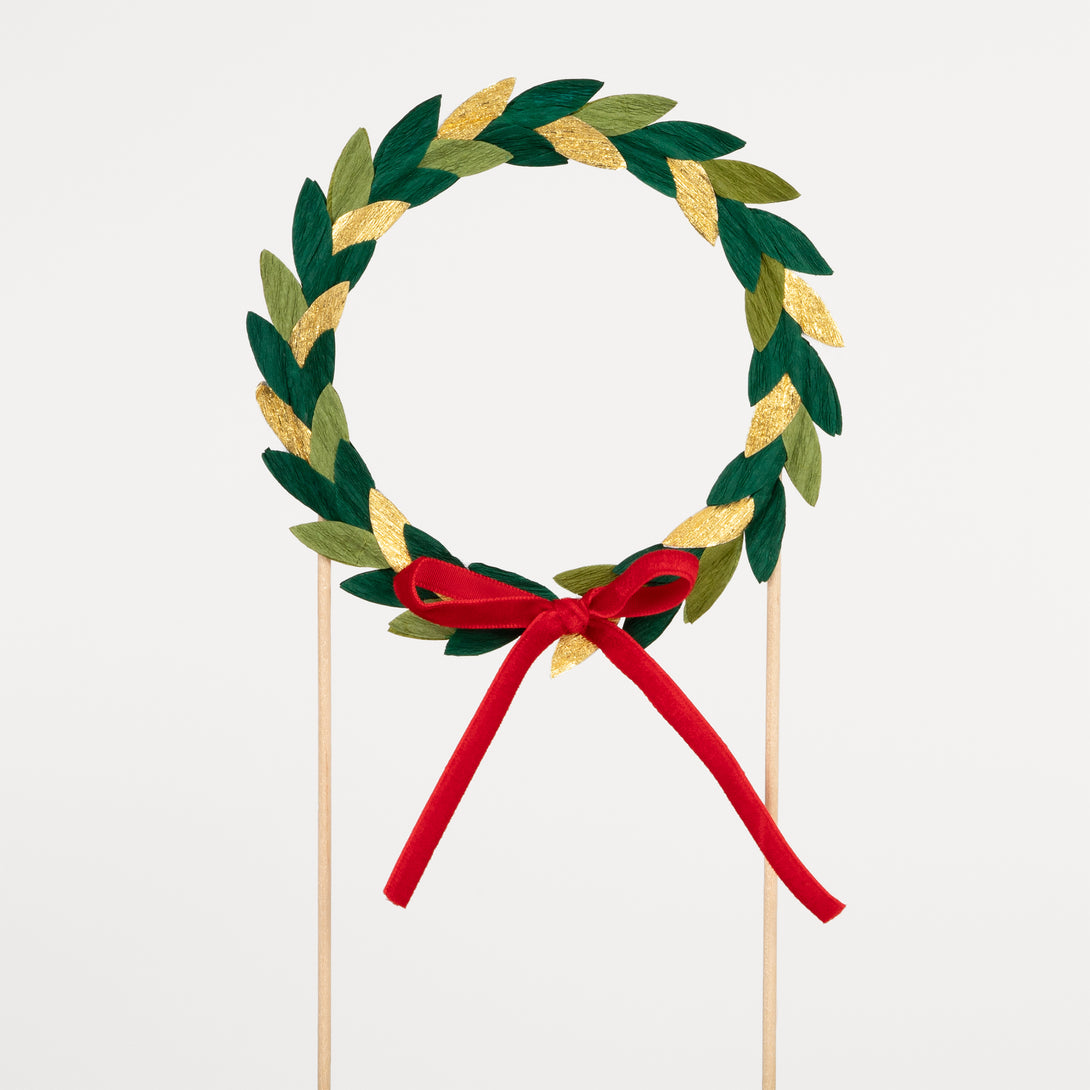 Our Christmas cake topper, a festive wreath with paper leaves and a velvet bow, is the perfect Christmas cake decoration.