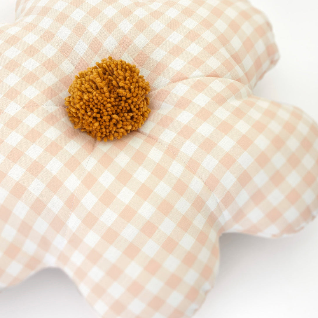 This decorative gingham print cushion is crafted in the shape of a daisy with a fun pompom center.