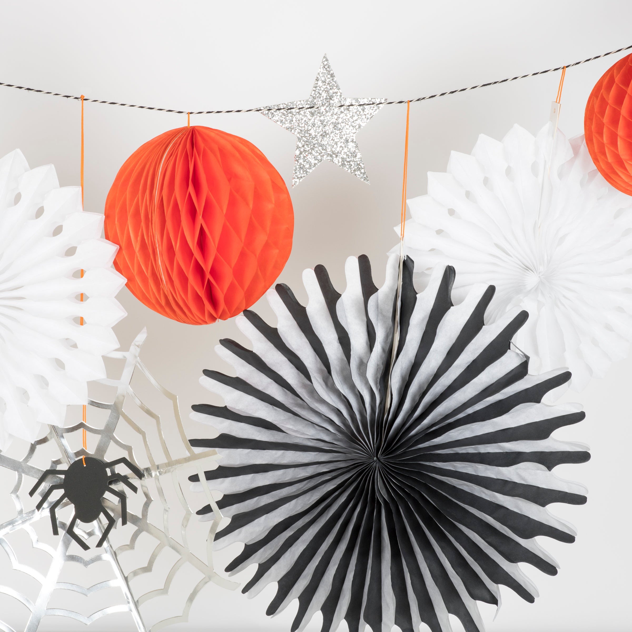 Our Halloween wall decoration features spiders, cobwebs, pinwheels, stars, honeycomb balls and a moon.