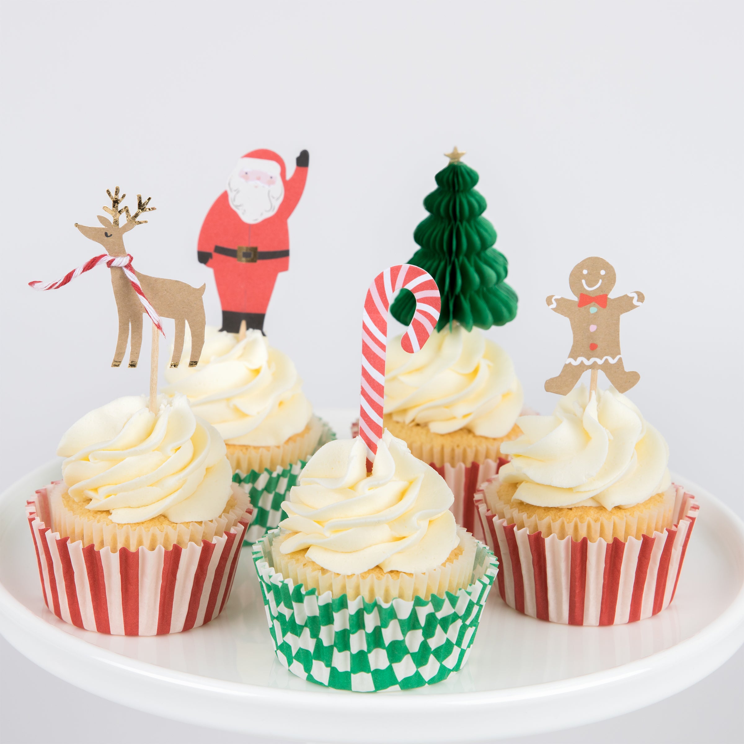 Make Christmas cupcakes with our Christmas cake toppers and cupcake cases, in a kit designed to look like a merry festive house.