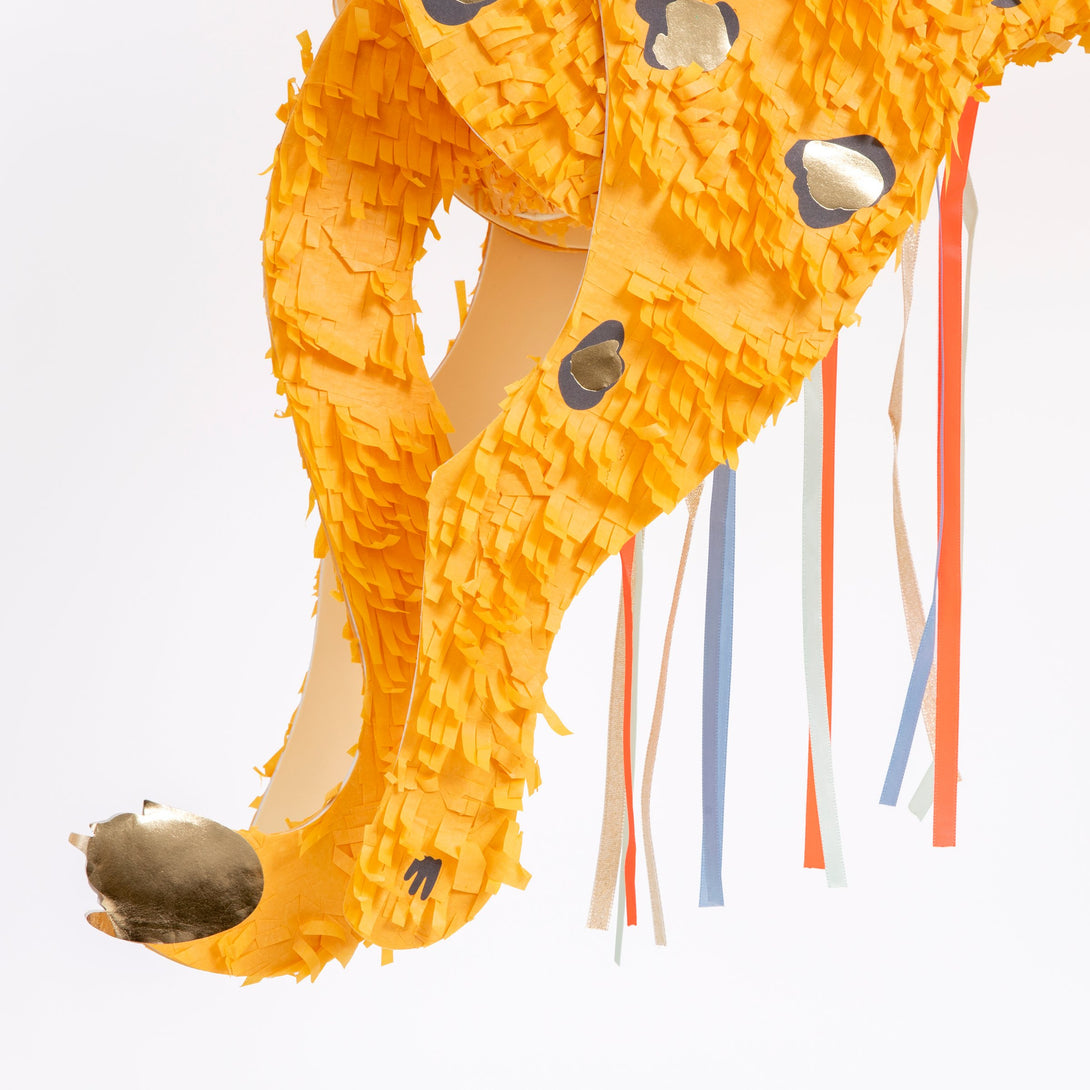 Add fun to your safari party theme with our cheetah piñata crafted with colorful ribbons, ready to fill with your own candy and treats.