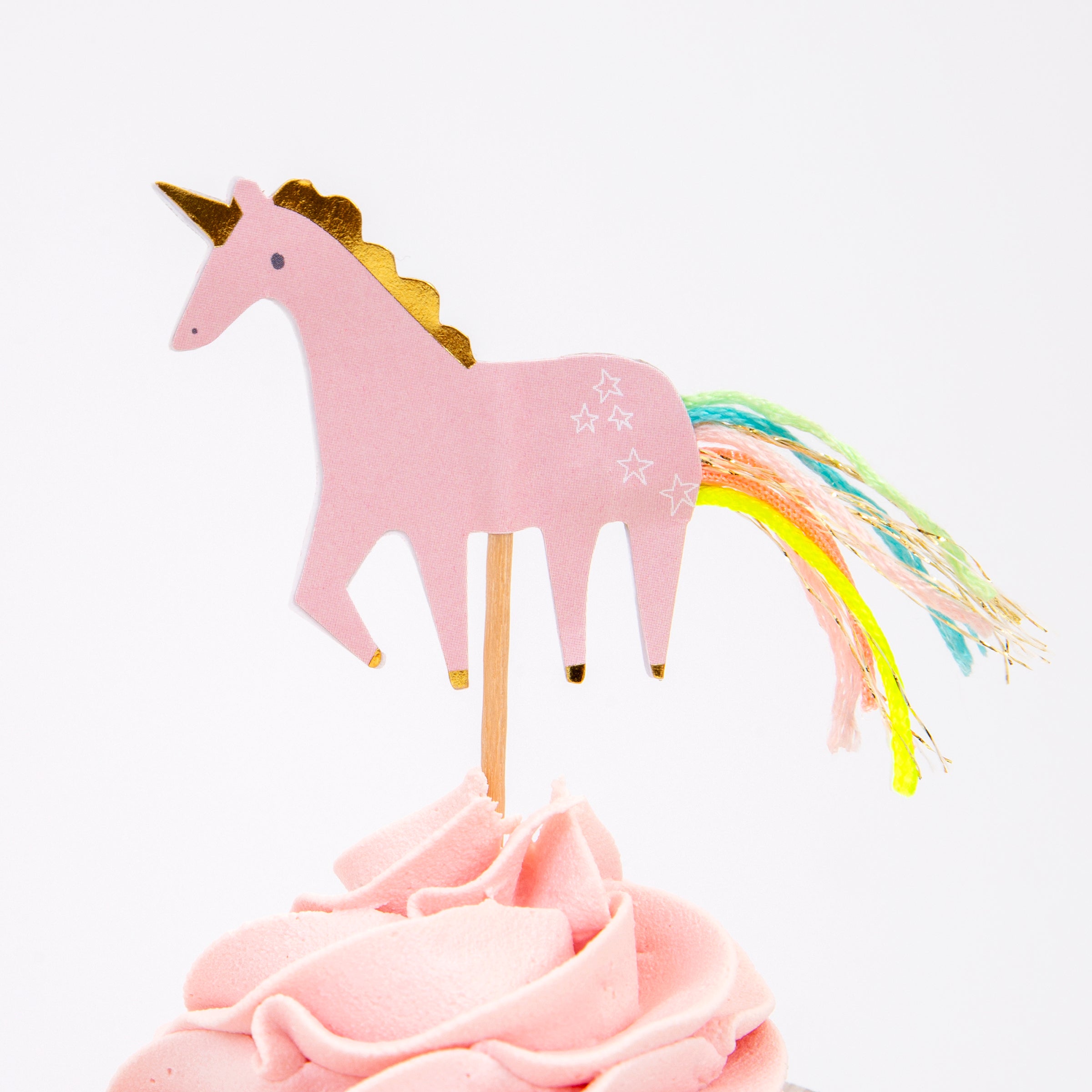 The kit includes shiny gold cupcake cases and rainbow and unicorn toppers, beautifully embellished with thread and gold foil.