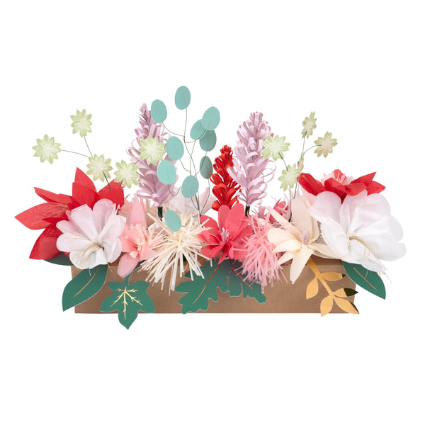 This Christmas table decoration is crafted from tissue paper flowers and foil topped paper leaves for a special look.