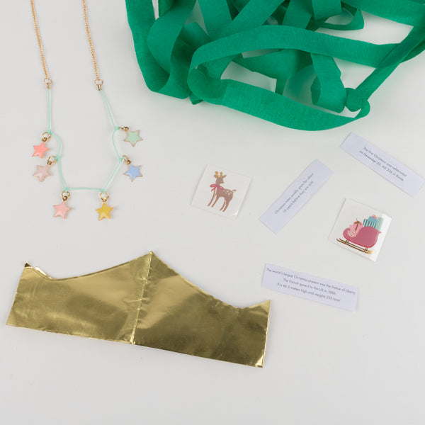 This surprise ball, in the shape of a Christmas tree, contains a necklace, gold party hat, temporary tattoos for kids and stickers for kids. Image5