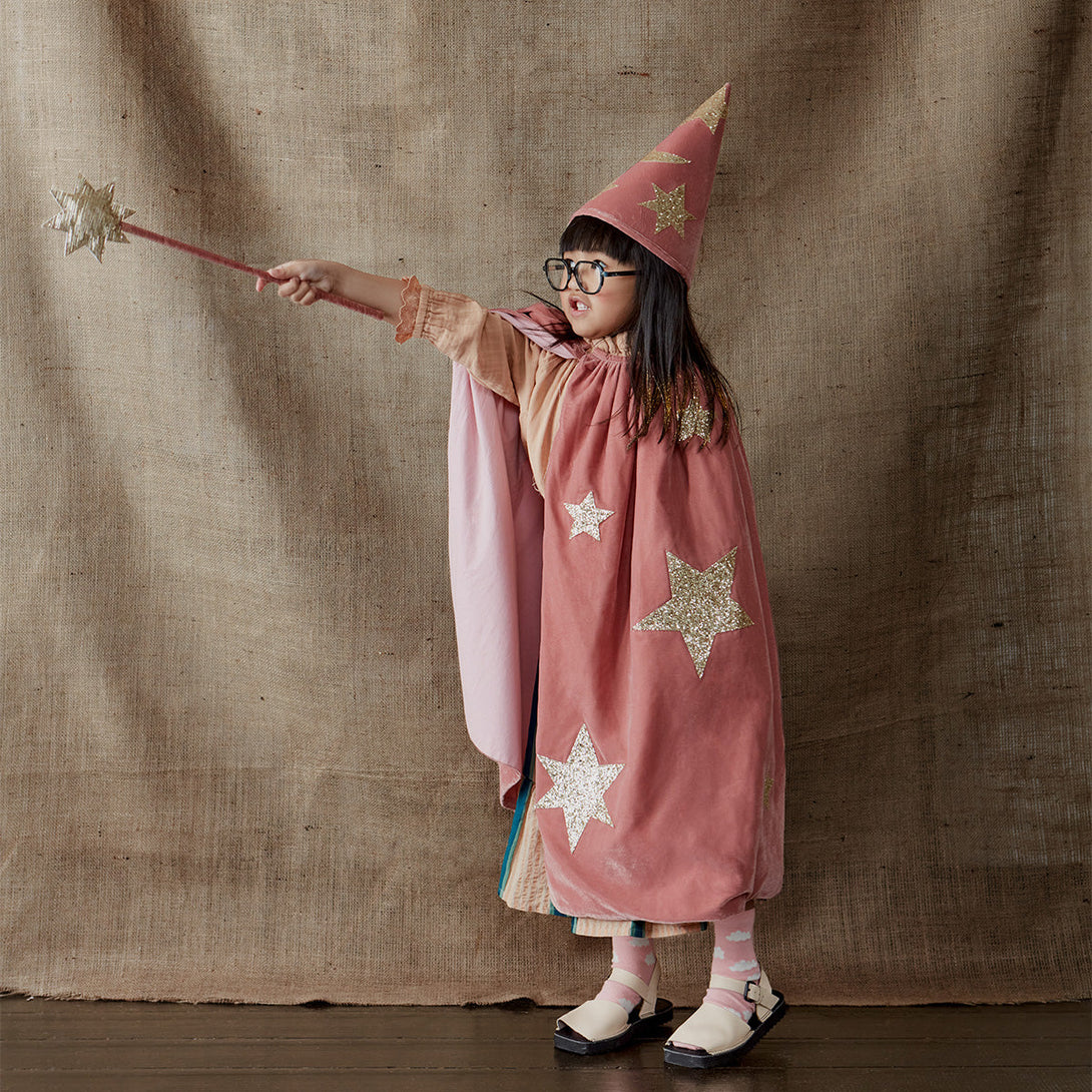 This wizard cape, wizard hat and star wand set, crafted from pink velvet and gold glitter fabric, is a fabulous costume for girls.