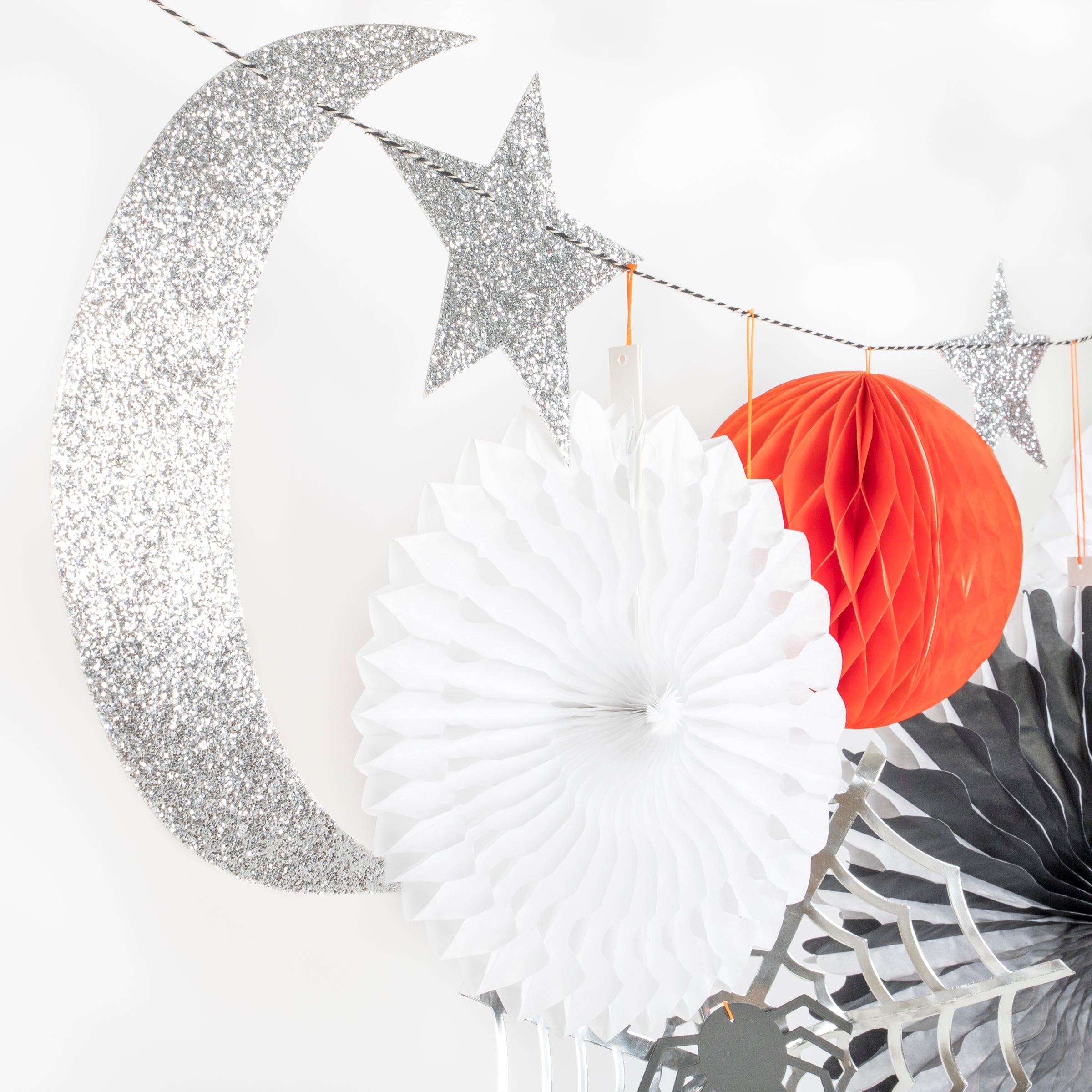 Our Halloween wall decoration features spiders, cobwebs, pinwheels, stars, honeycomb balls and a moon.