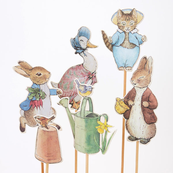 The set has 6 designs, including Peter Rabbit, Tom Kitten, Jemima Puddle-duck, Benjamin Bunny, a watering can, and a  bird. Image2