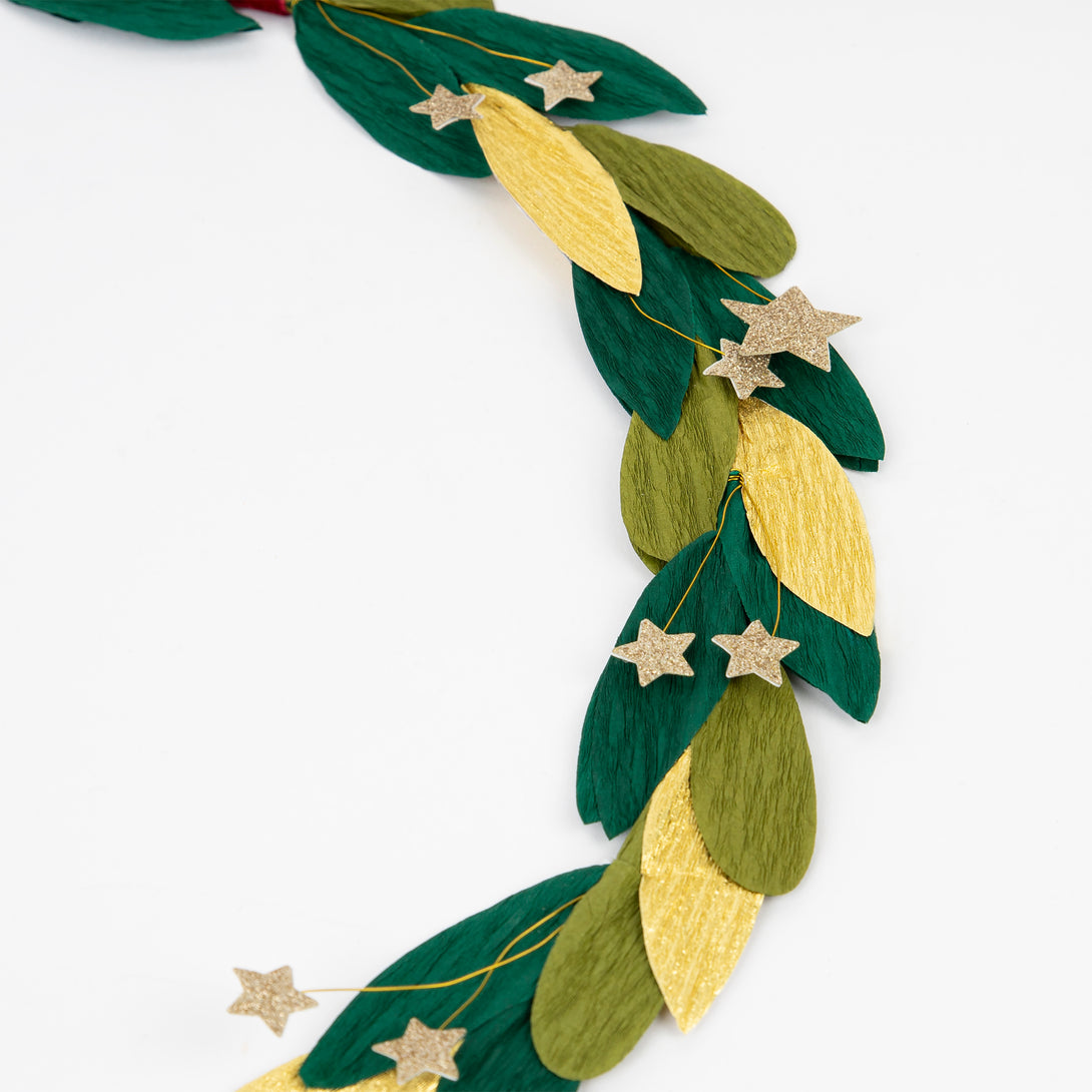 Our star wreath has gold glitter stars, paper leaves and a velvet ribbon and bow.