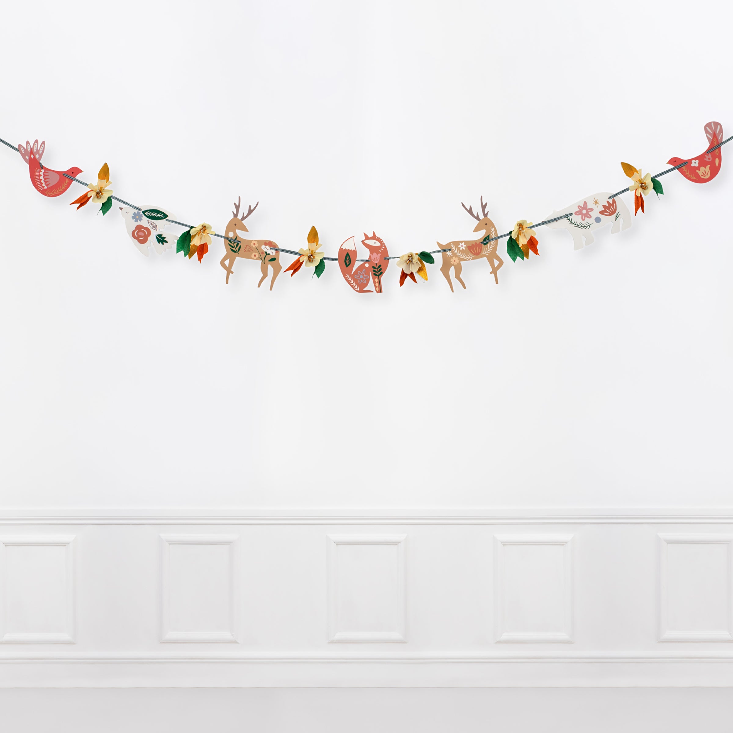 This beautiful Thankgiving garland is made from crepe paper decorations including flowers and leaves.