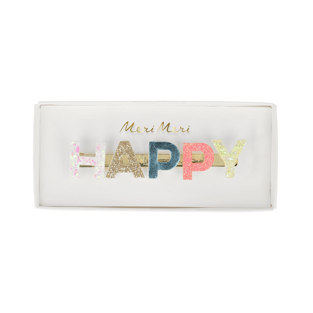 Our gold hair clip features the word "Happy" in leatherette and glitter lettering.