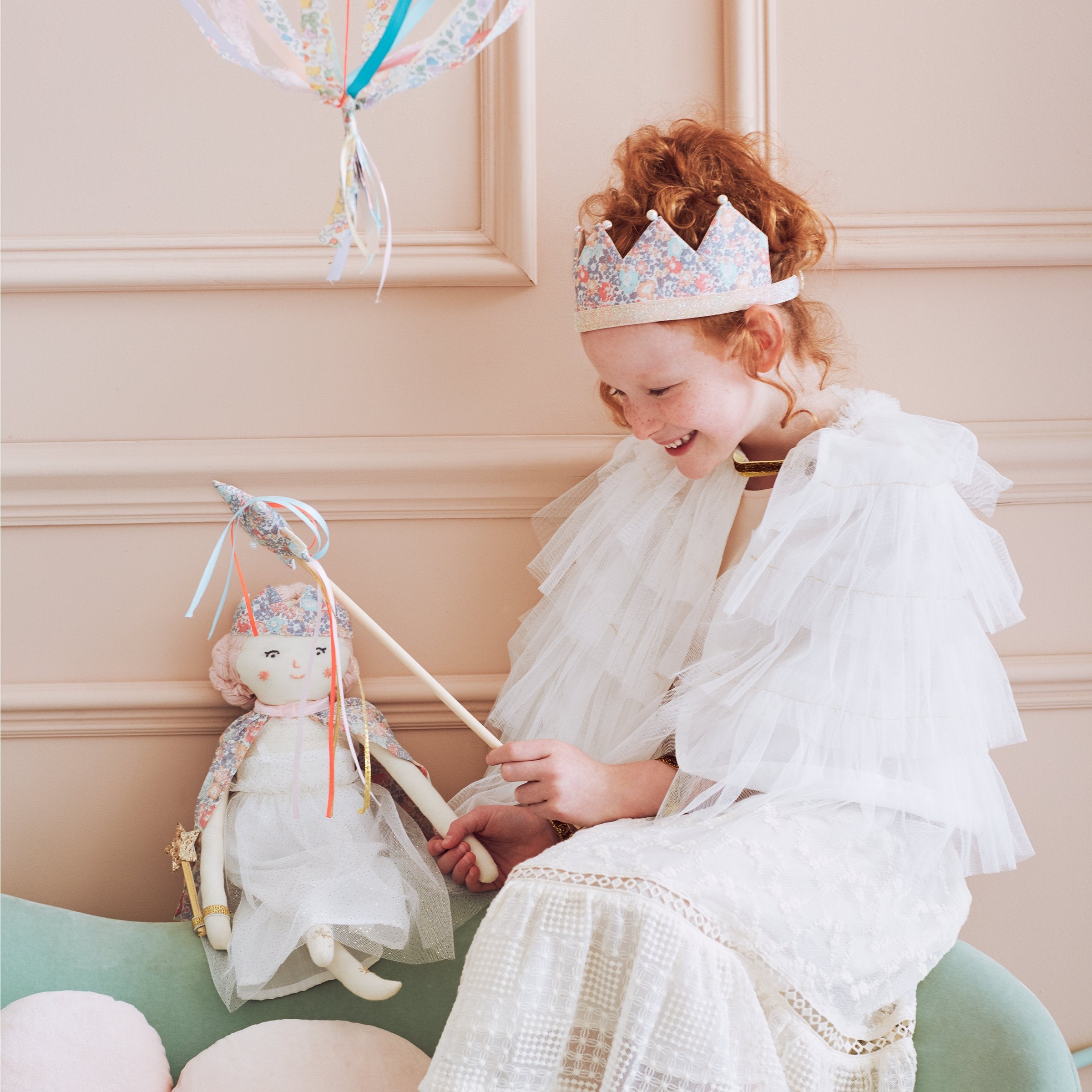 This beautiful princess doll has a white tulle dress with a Liberty floral cape, a crown and a star wand.