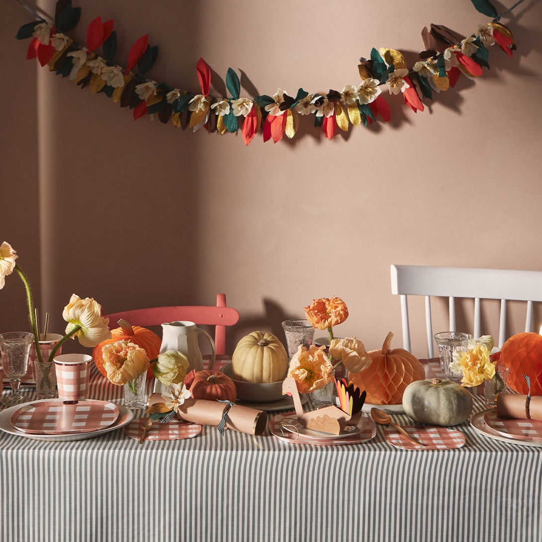 This paper flower garland, with paper leaves, makes a stunning Thanksgiving decoration idea.