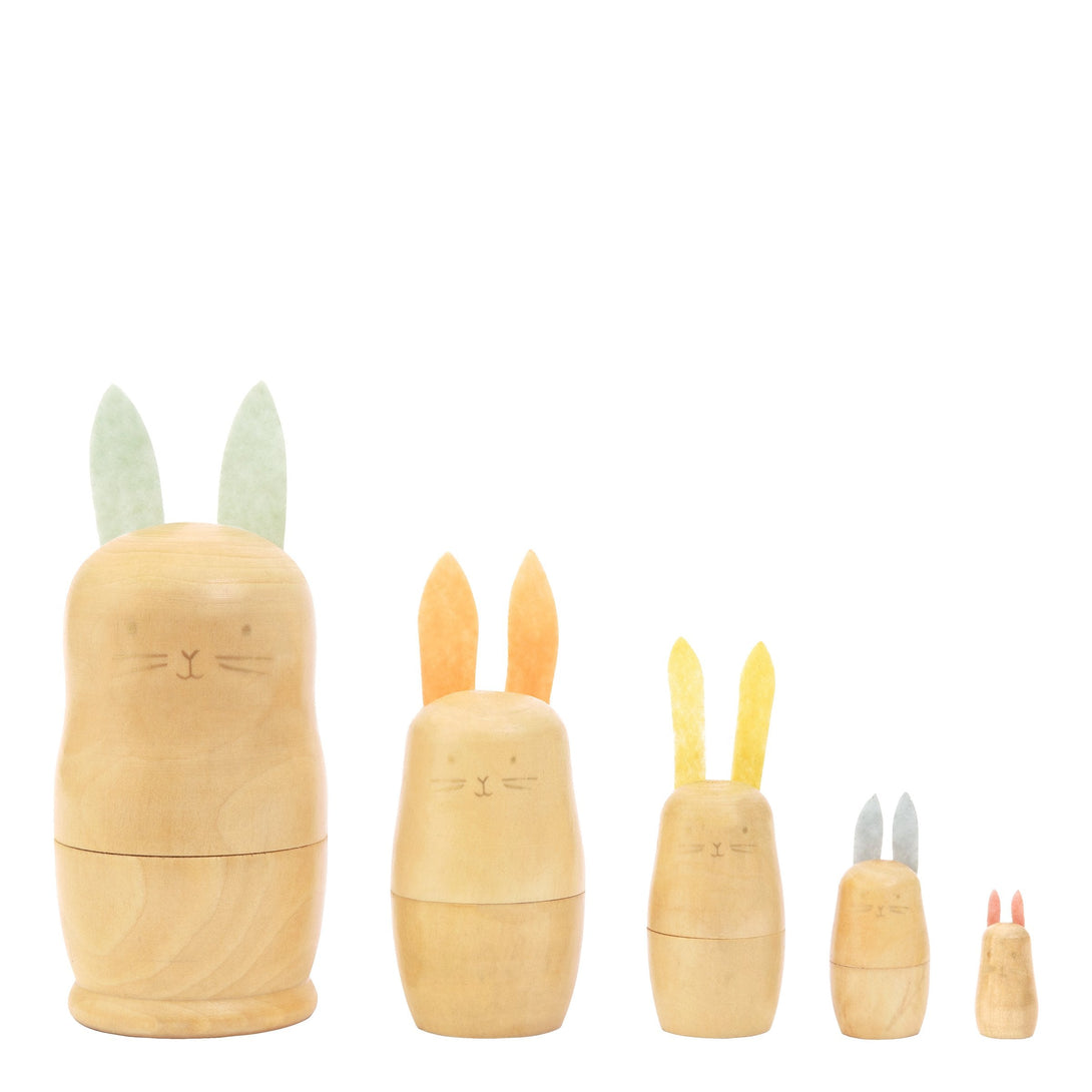 These stacking bunnies are crafted from wood, with gold features, and felt ears and tails.