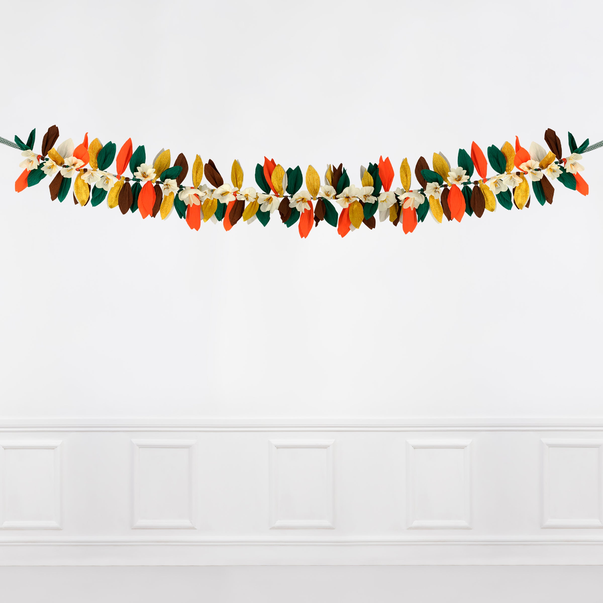 This paper flower garland, with paper leaves, makes a stunning Thanksgiving decoration idea.