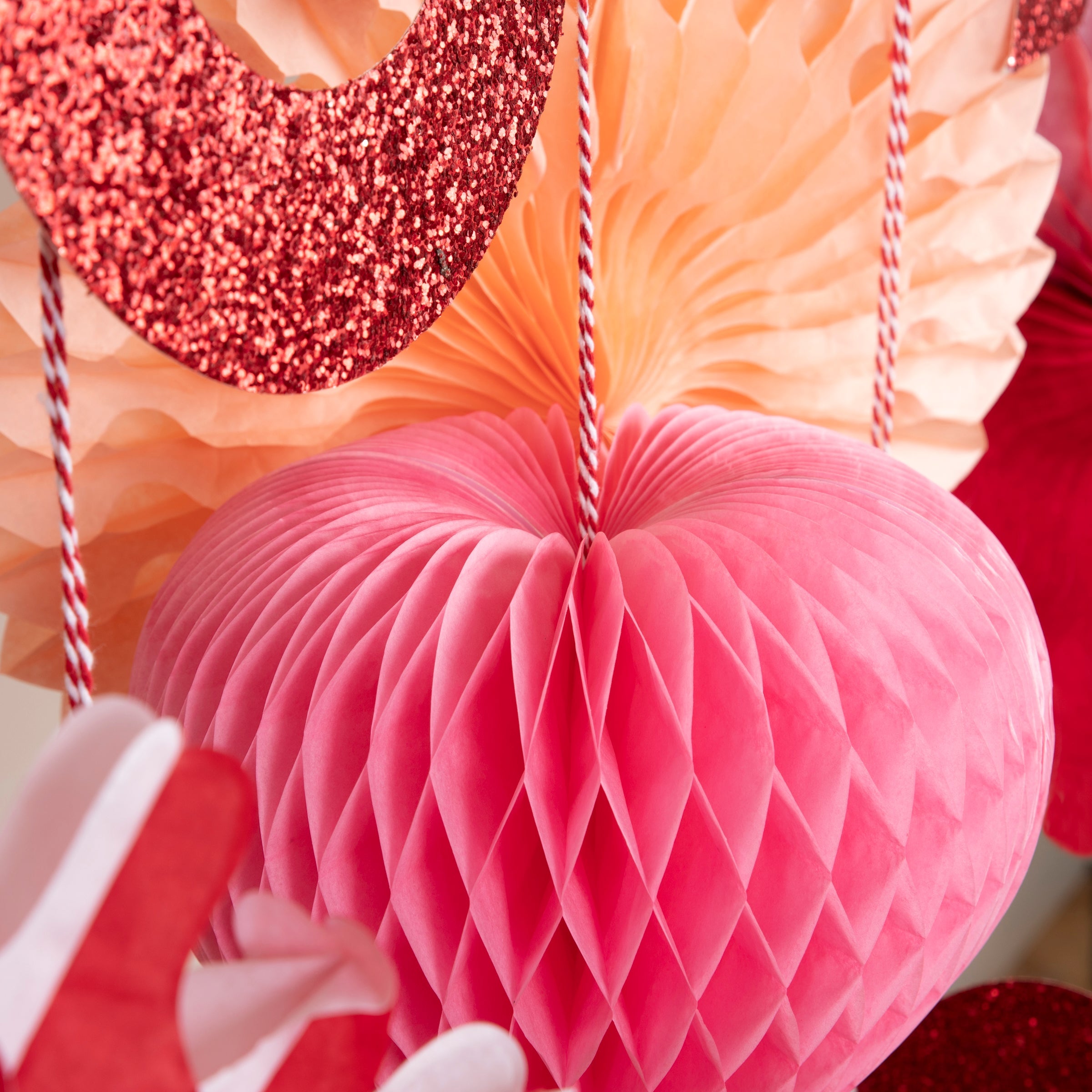 Our large heart garland features honeycomb and glitter hearts.