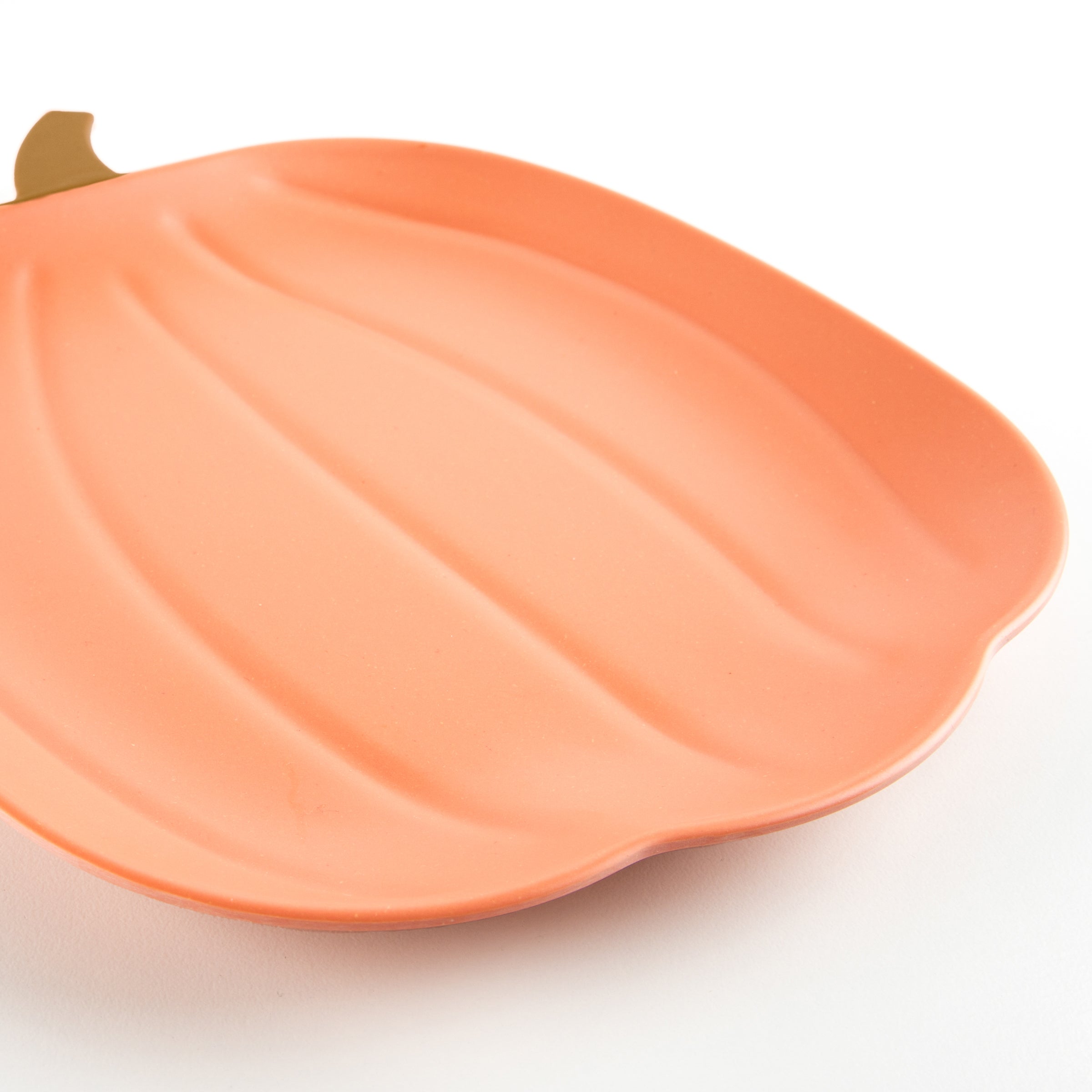 Our orange pumpkin plate is a bamboo plate that is reusable for many Halloween parties.