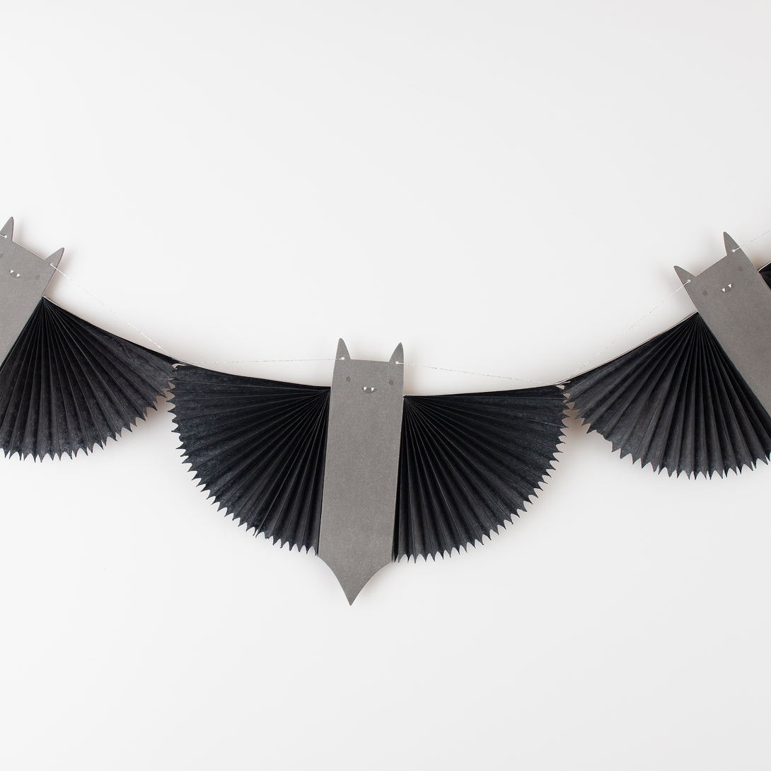 Our paper garland features black bats with 3D wings and big smiles, perfect as kid friendly Halloween decorations.